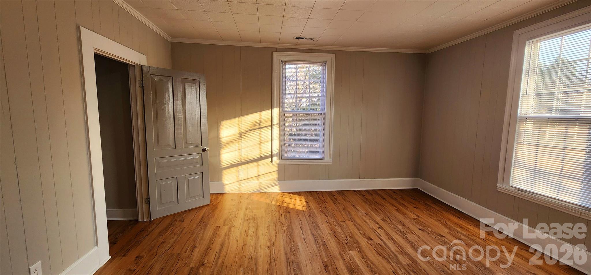 359 Flat Rock Road Lawndale, NC 28090 - Photo 17 of 19 an empty room with wooden floor and windows