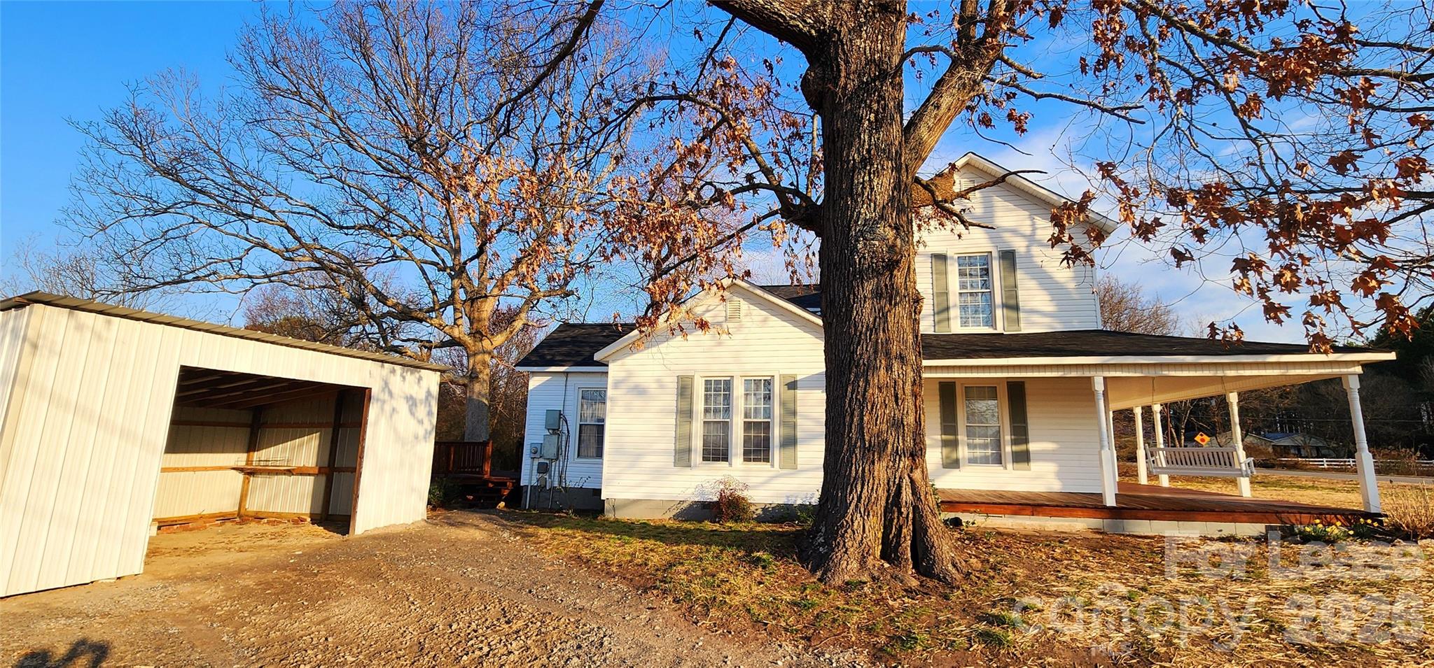 359 Flat Rock Road Lawndale, NC 28090 - Photo 3 of 19 a front view of a house with a large tree
