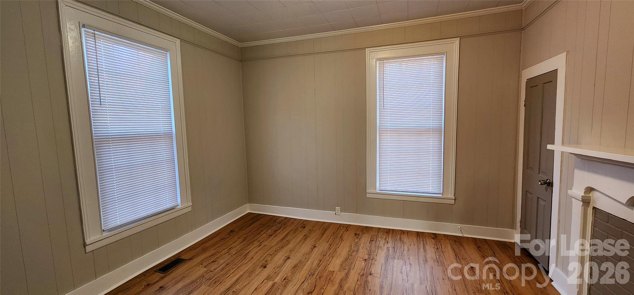 359 Flat Rock Road Lawndale, NC 28090 - Photo 6 of 19 an empty room with wooden floor and windows