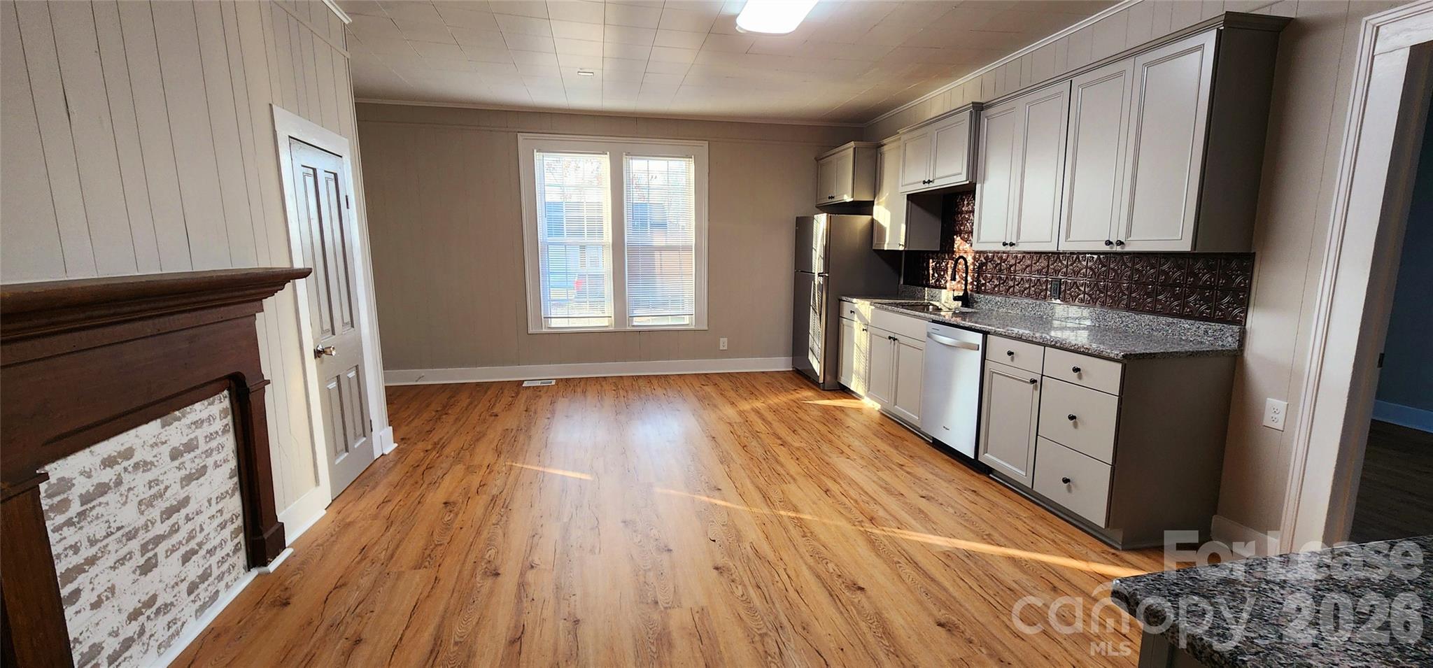 359 Flat Rock Road Lawndale, NC 28090 - Photo 9 of 19 a kitchen with wooden floors and a fireplace