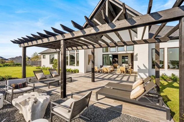a view of a backyard with swimming pool and sitting area
