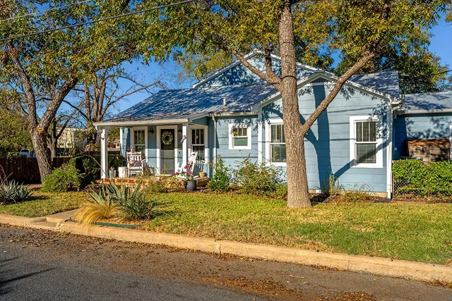 a front view of a house with garden