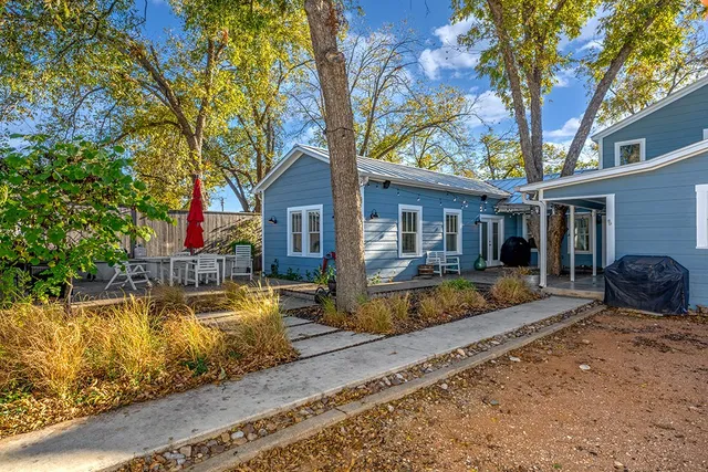 a view of a backyard with sitting area