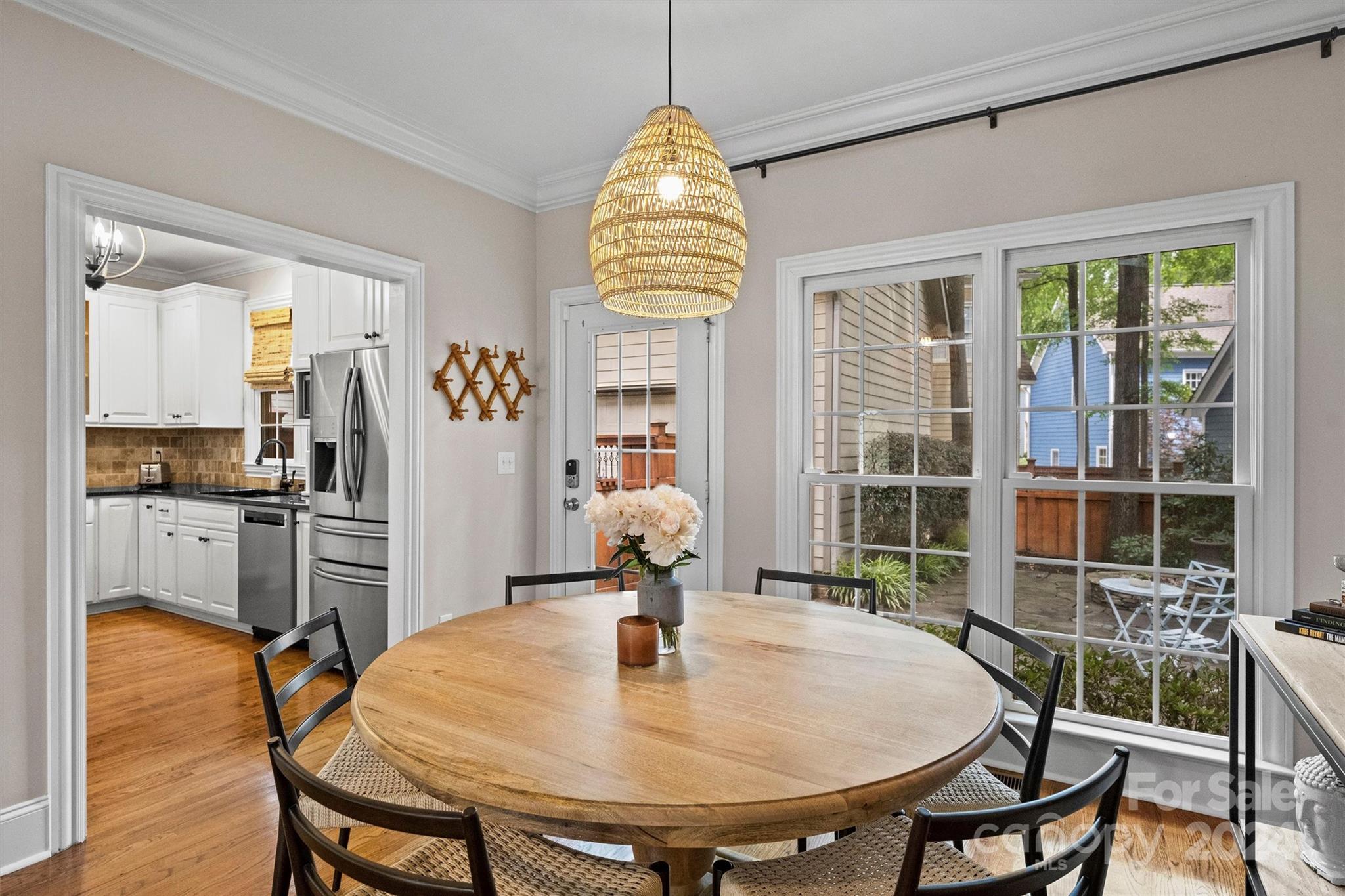 813 Millbrook Road Charlotte, NC 28211 - Photo 12 of 47 a dining room filled chandelier and wooden floor