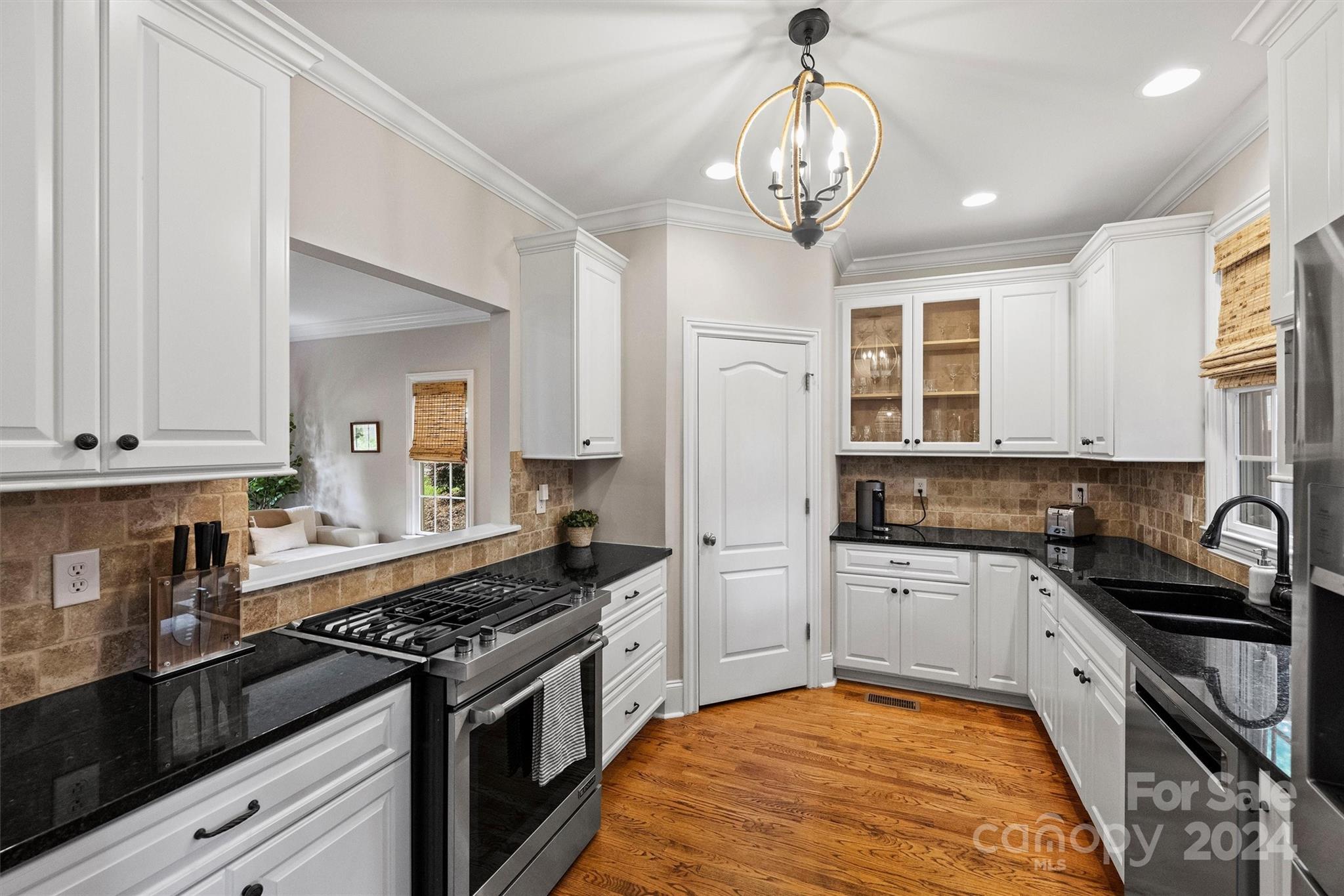 813 Millbrook Road Charlotte, NC 28211 - Photo 19 of 47 a kitchen with granite countertop stainless steel appliances a sink stove top oven and cabinets
