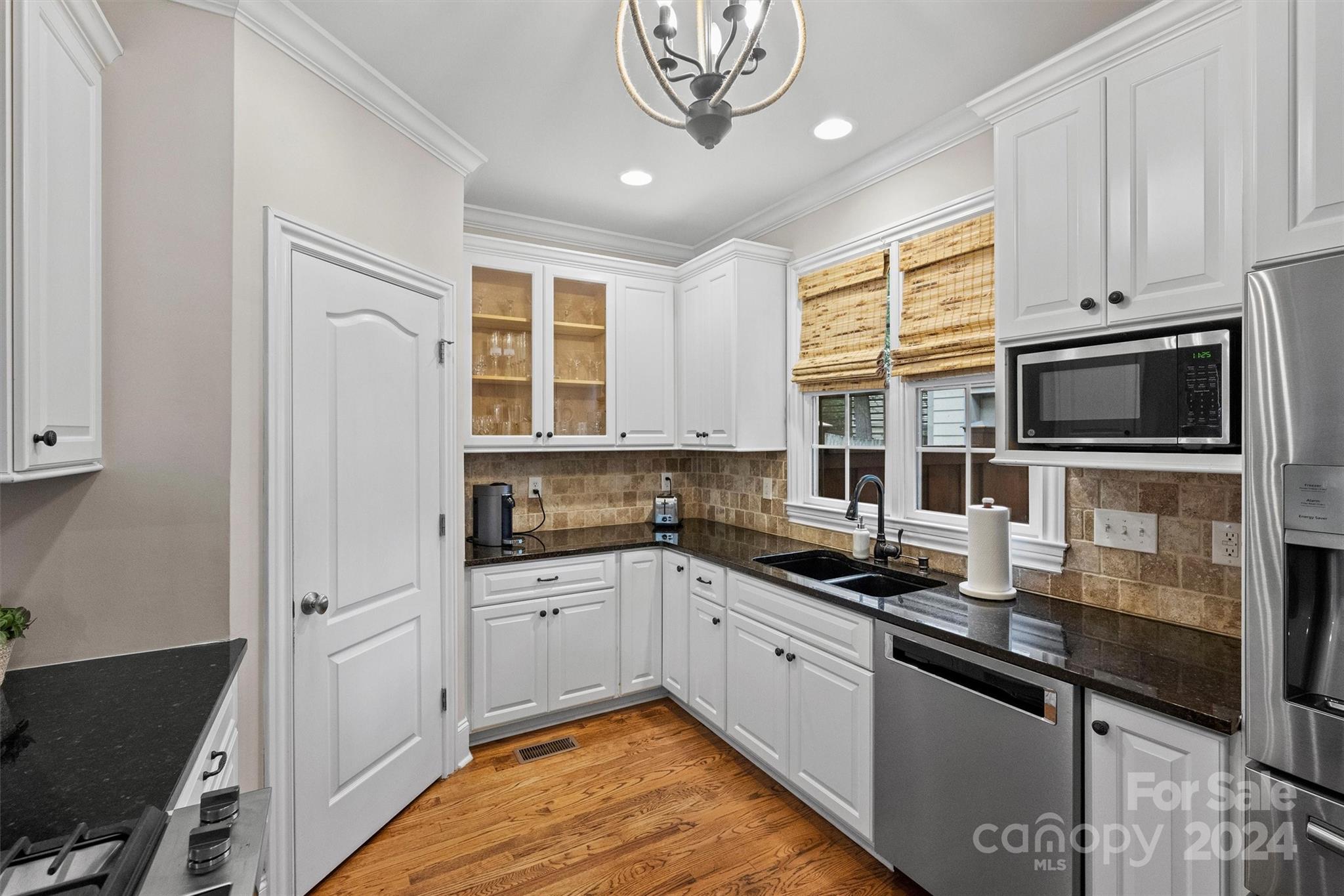 813 Millbrook Road Charlotte, NC 28211 - Photo 20 of 47 a kitchen with stainless steel appliances granite countertop a stove and a sink