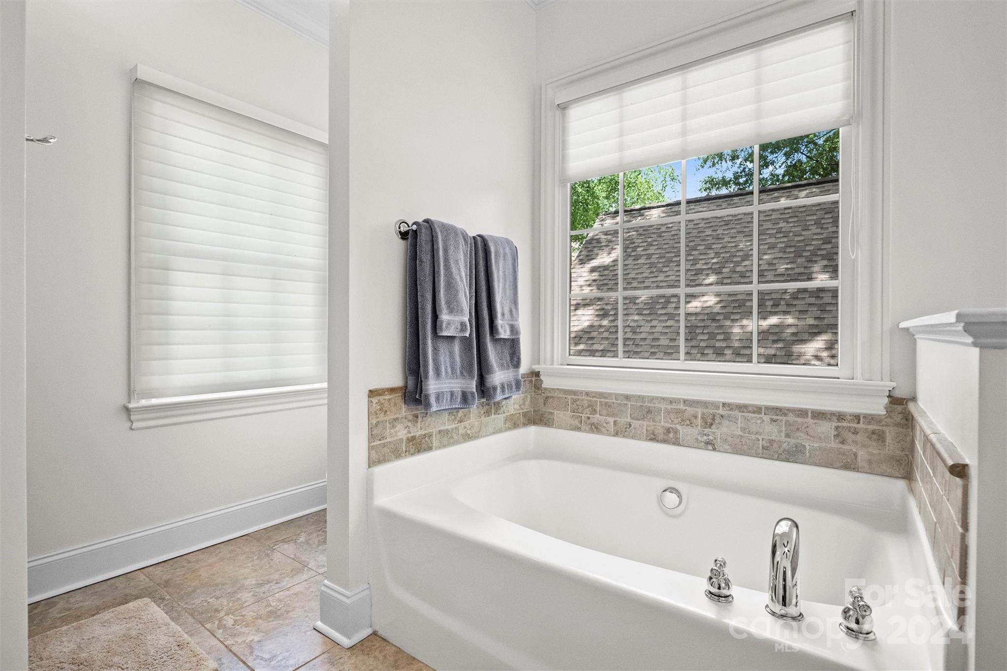 813 Millbrook Road Charlotte, NC 28211 - Photo 28 of 47 a bath tub sitting next to a window