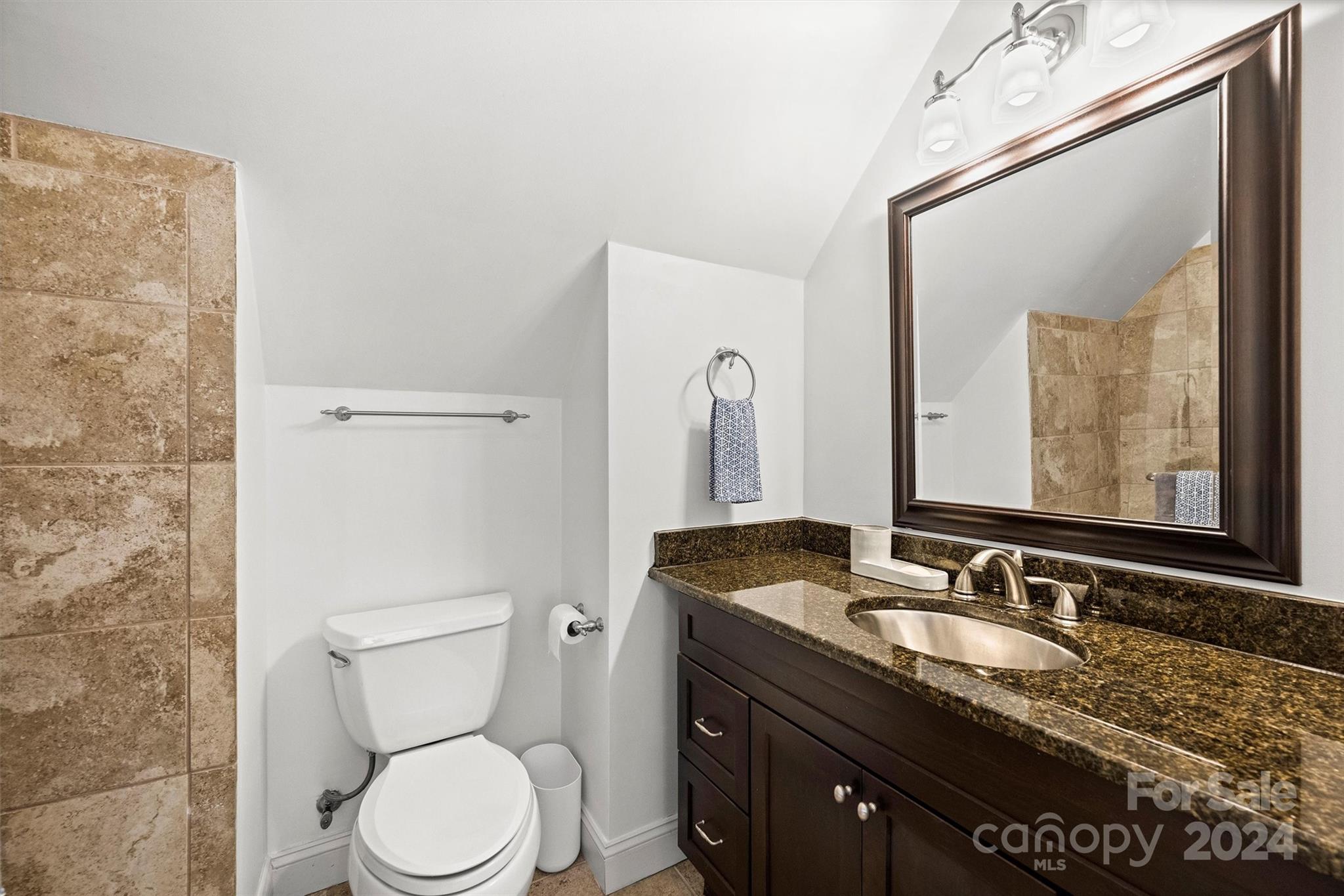 813 Millbrook Road Charlotte, NC 28211 - Photo 34 of 47 a bathroom with a granite countertop sink toilet and mirror