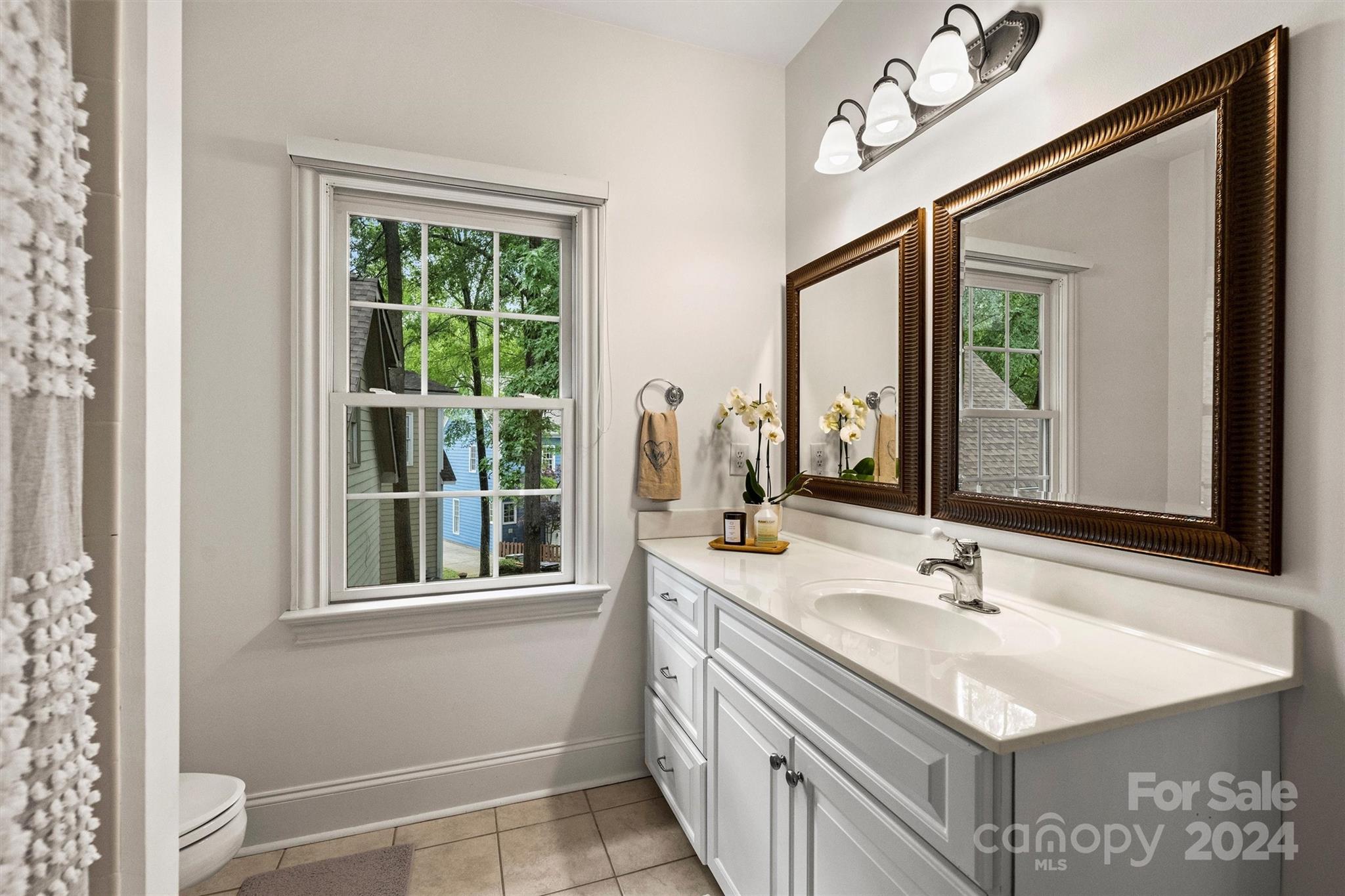 813 Millbrook Road Charlotte, NC 28211 - Photo 35 of 47 a bathroom with a sink and a mirror