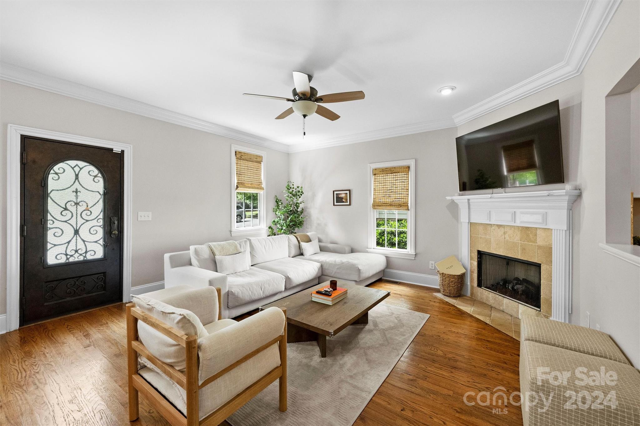 813 Millbrook Road Charlotte, NC 28211 - Photo 4 of 47 a living room with furniture a fireplace and a flat screen tv