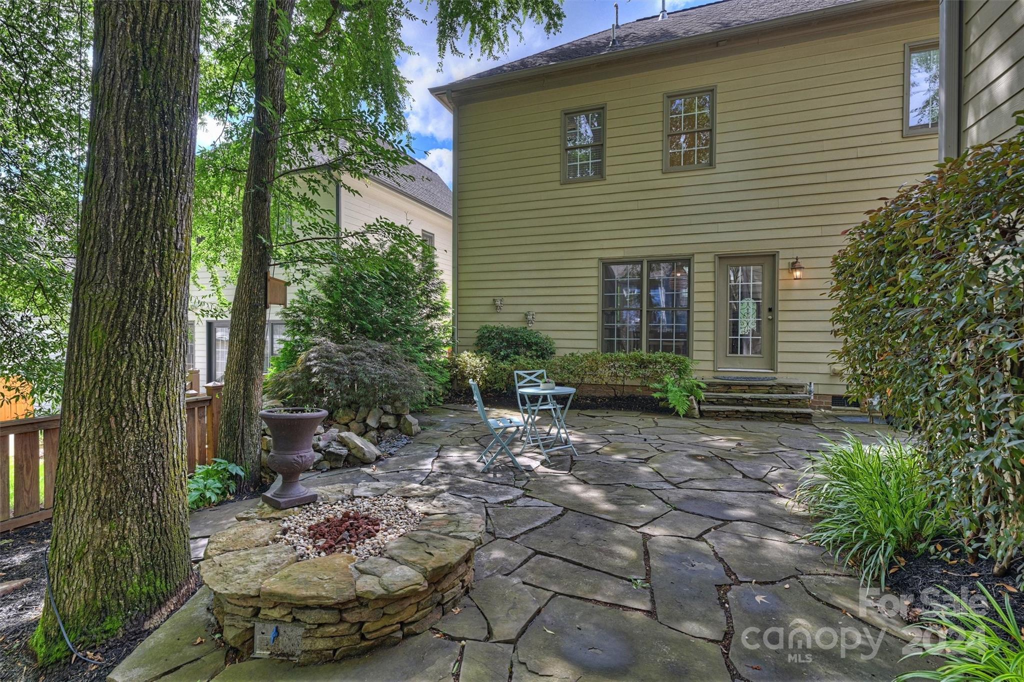 813 Millbrook Road Charlotte, NC 28211 - Photo 46 of 47 a view of a backyard with plants and outdoor seating