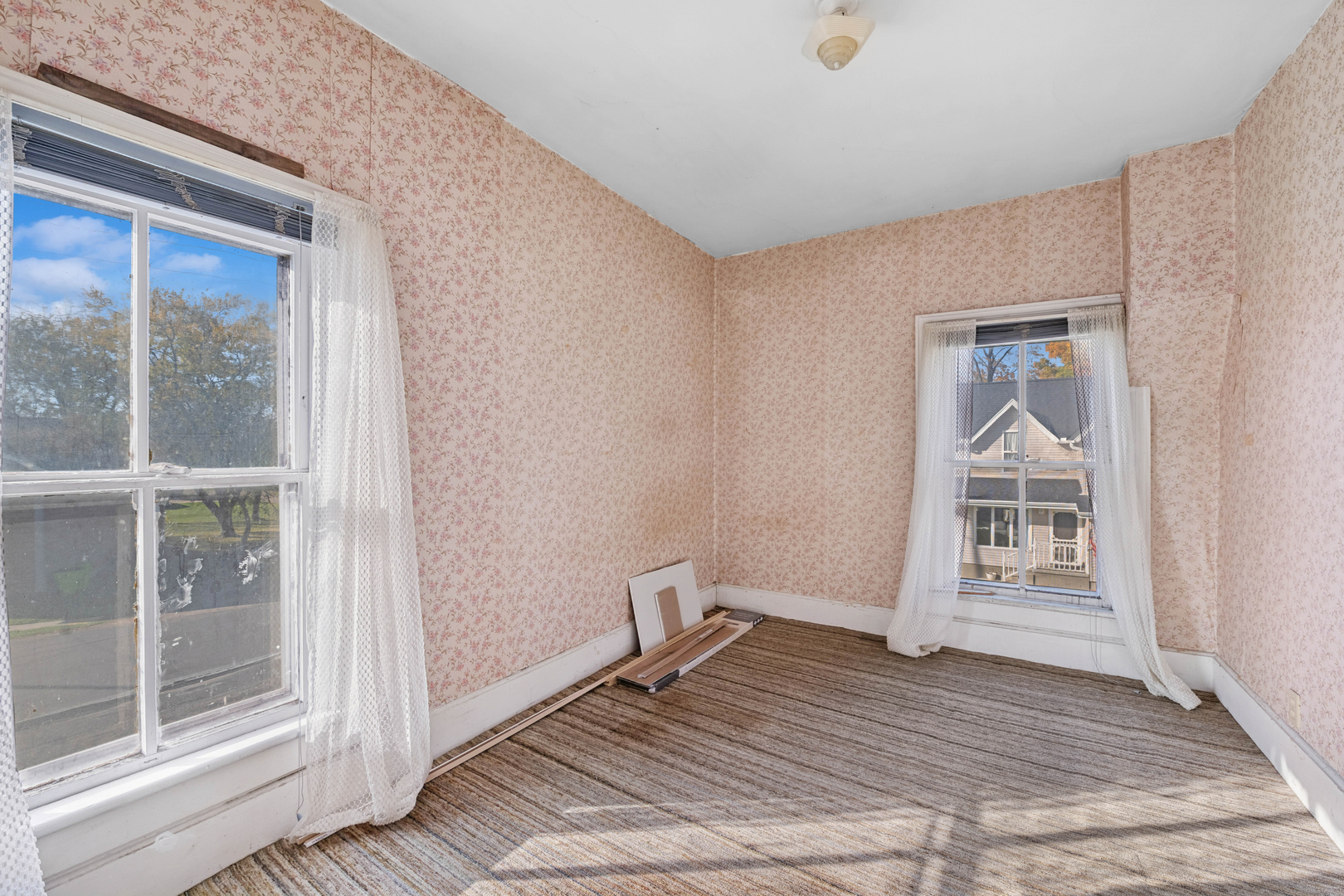 130 Seymour Street Sharon, WI 53585 - Photo 12 of 23 a view of an empty room with wooden floor and a window