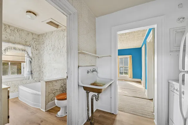 a bathroom with a tub shower and mirror