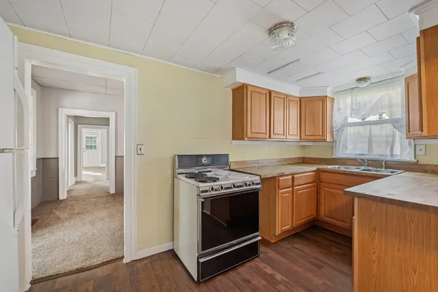 a kitchen with stainless steel appliances granite countertop a stove and a sink