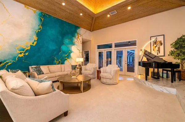 a view of a dining room with furniture a chandelier and wooden floor