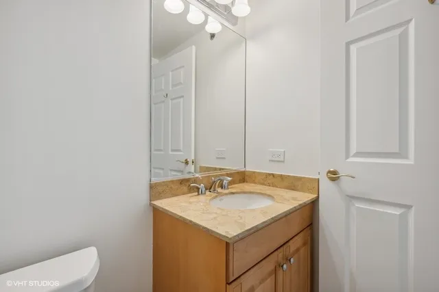 a bathroom with a sink toilet and vanity