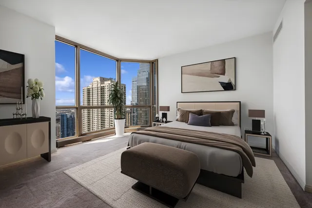 a bedroom with a balcony a bed and a television