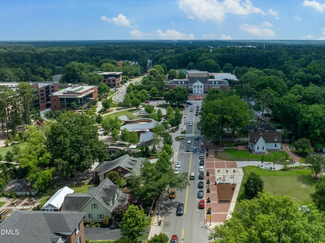 an aerial view of residential houses with outdoor space and river