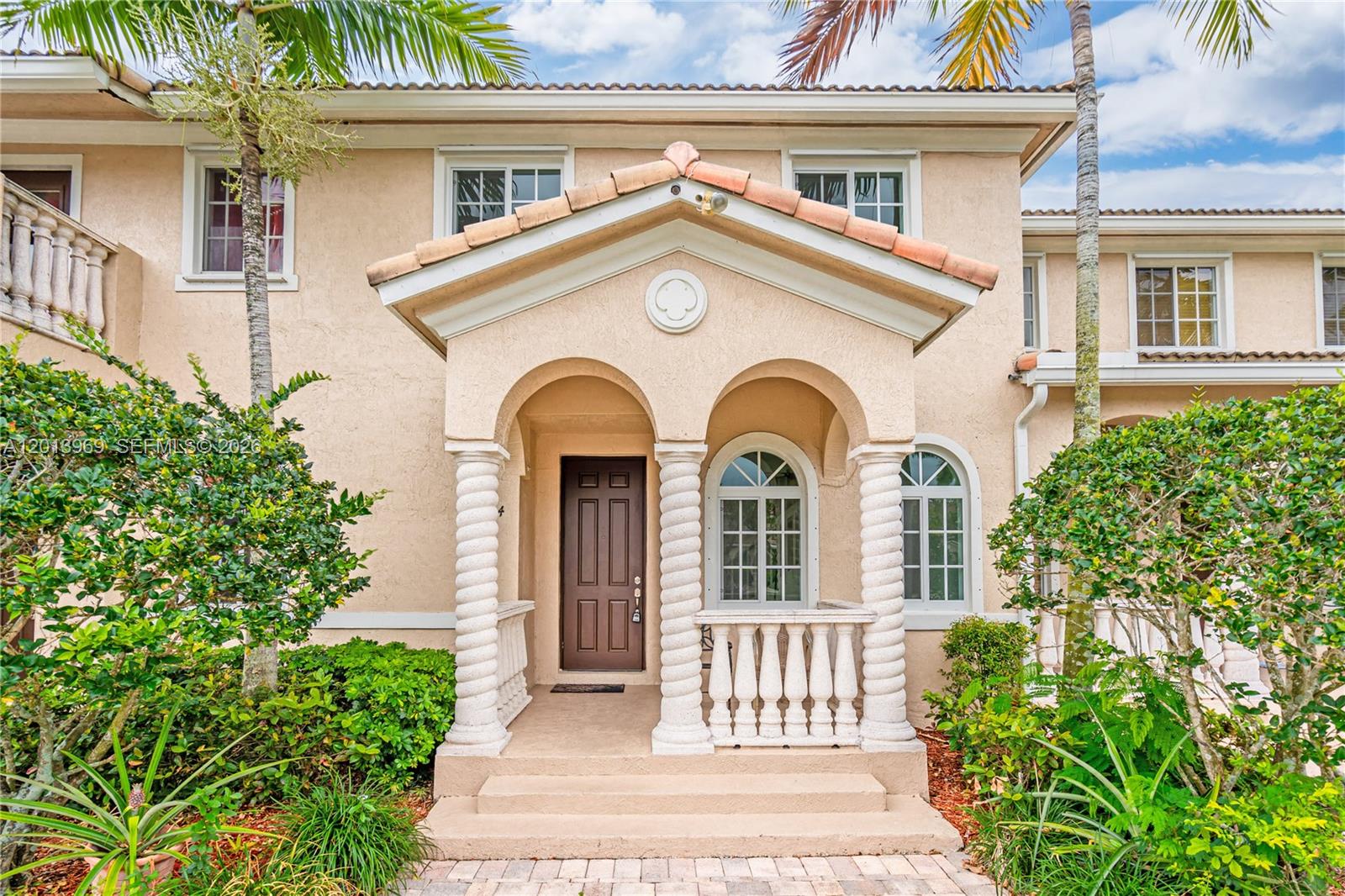 14044 Southwest 273rd Lane, Unit 14044 Homestead, FL 33032 - Photo 1 of 44 a view of a grey house with large windows