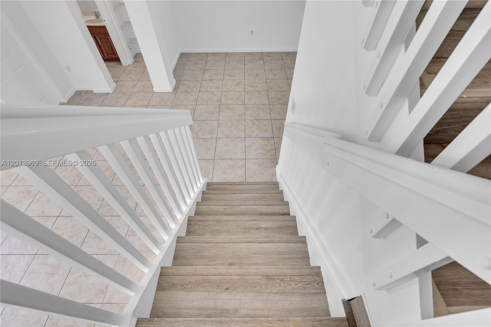 14044 Southwest 273rd Lane, Unit 14044 Homestead, FL 33032 - Photo 15 of 44 a view of staircase with white walls and windows