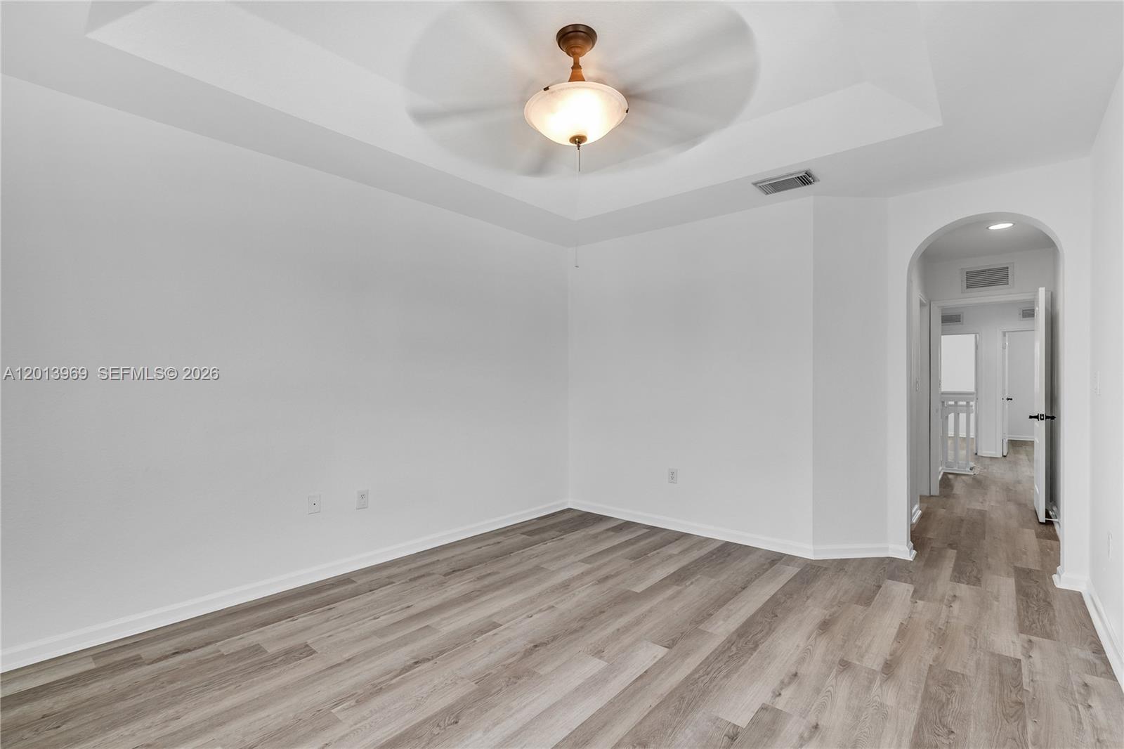 14044 Southwest 273rd Lane, Unit 14044 Homestead, FL 33032 - Photo 21 of 44 a view of empty room with wooden floor