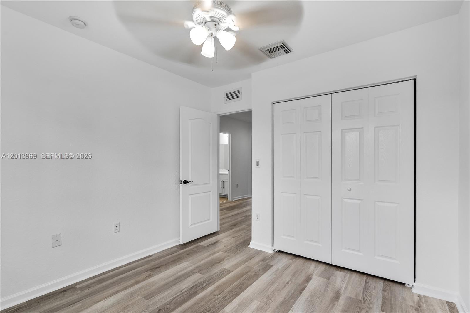 14044 Southwest 273rd Lane, Unit 14044 Homestead, FL 33032 - Photo 24 of 44 a view of an empty room with wooden floor