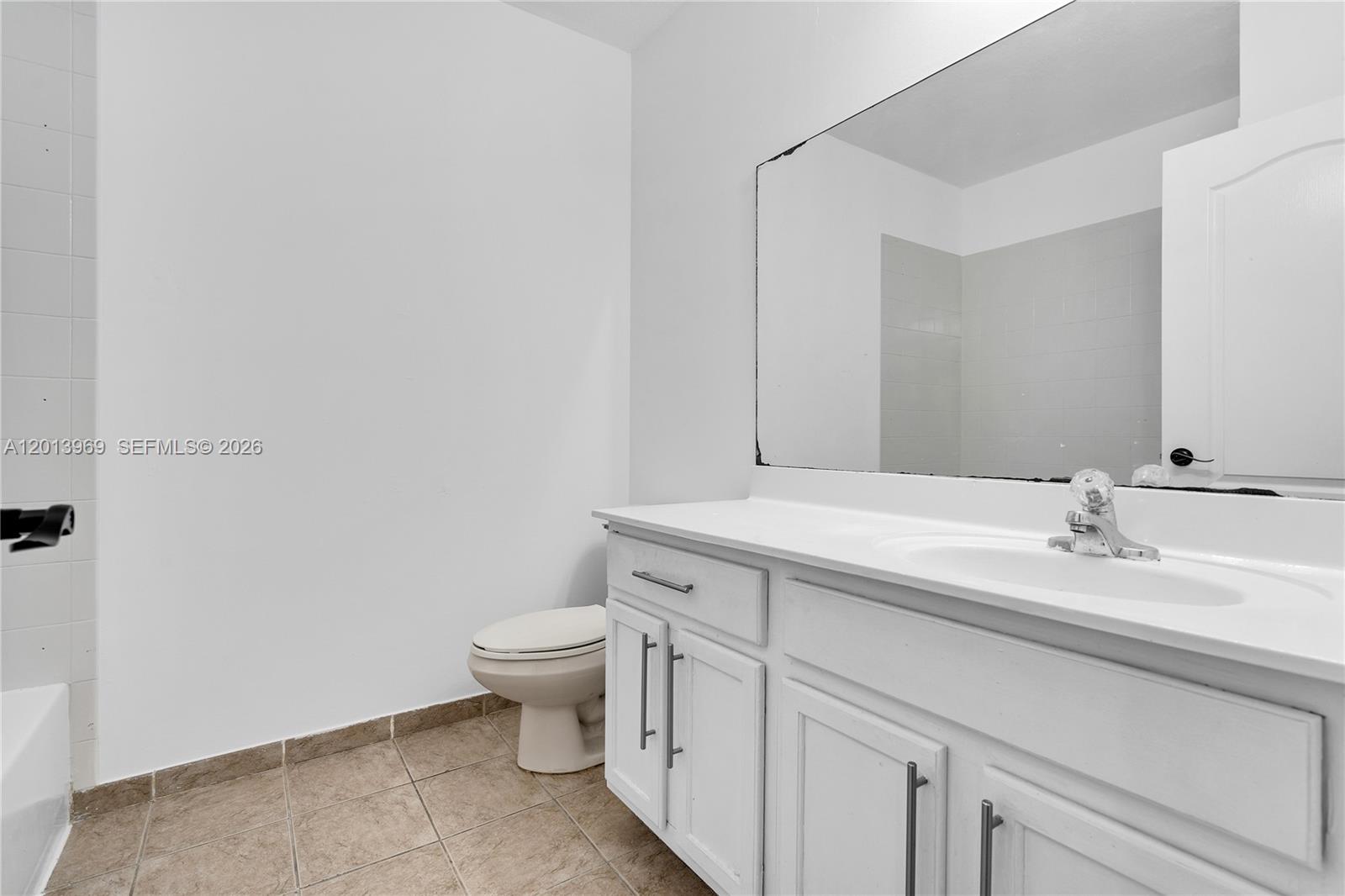 14044 Southwest 273rd Lane, Unit 14044 Homestead, FL 33032 - Photo 26 of 44 a bathroom with a granite countertop toilet and a sink