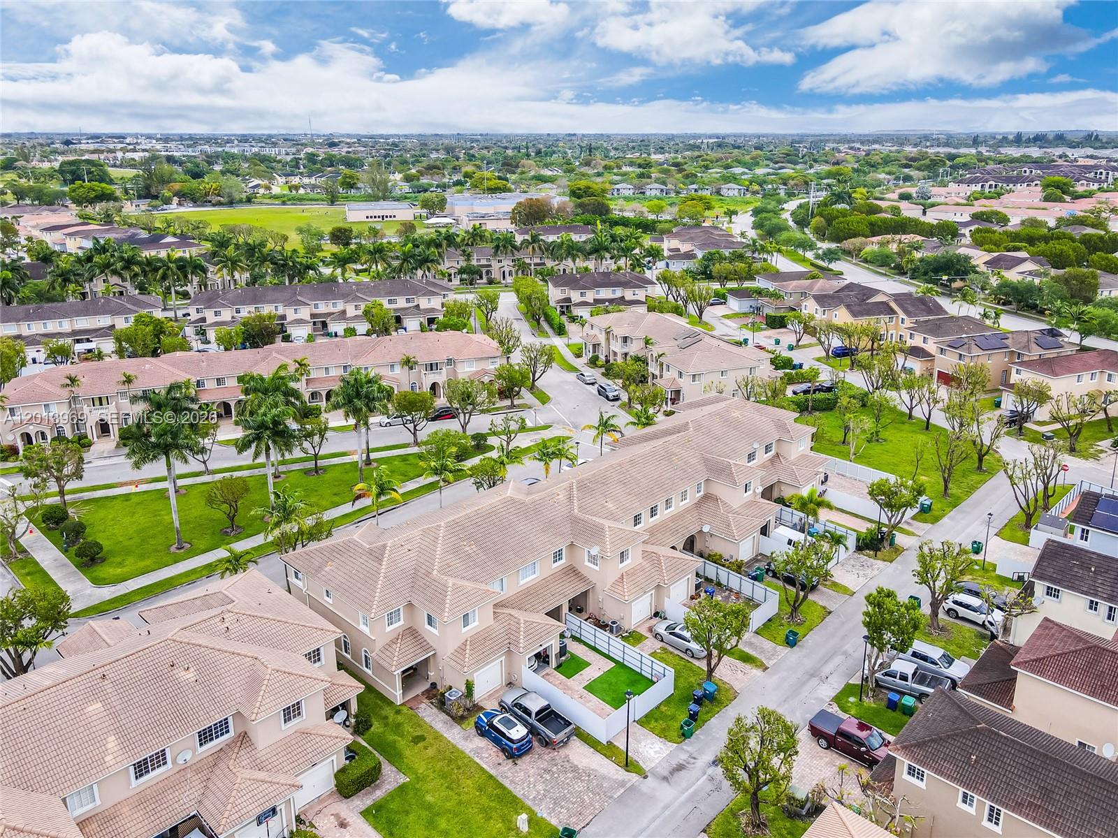 14044 Southwest 273rd Lane, Unit 14044 Homestead, FL 33032 - Photo 36 of 44 an aerial view of a city with lots of residential buildings ocean and mountain view in back