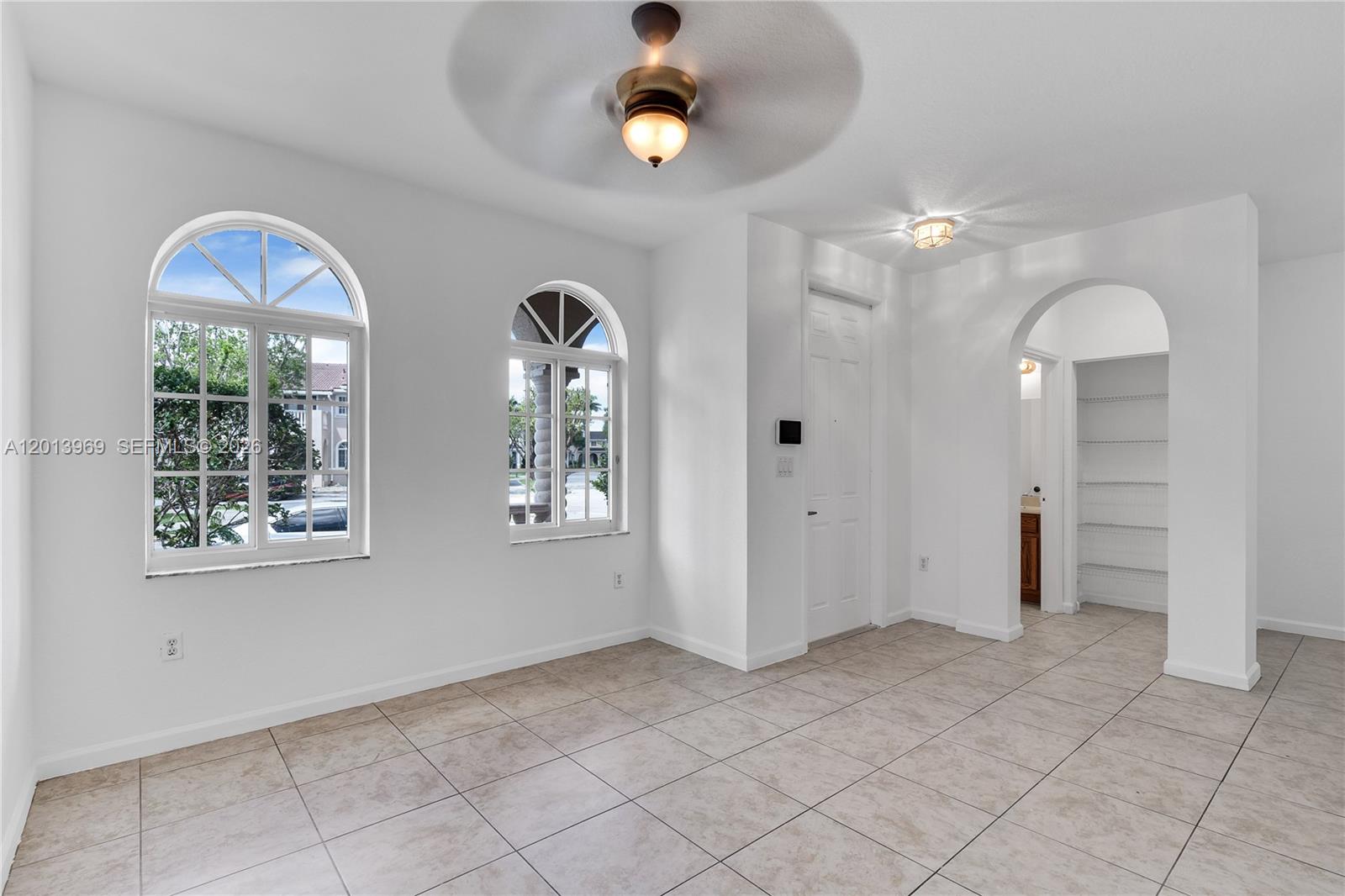 14044 Southwest 273rd Lane, Unit 14044 Homestead, FL 33032 - Photo 8 of 44 wooden floor in an empty room with a window
