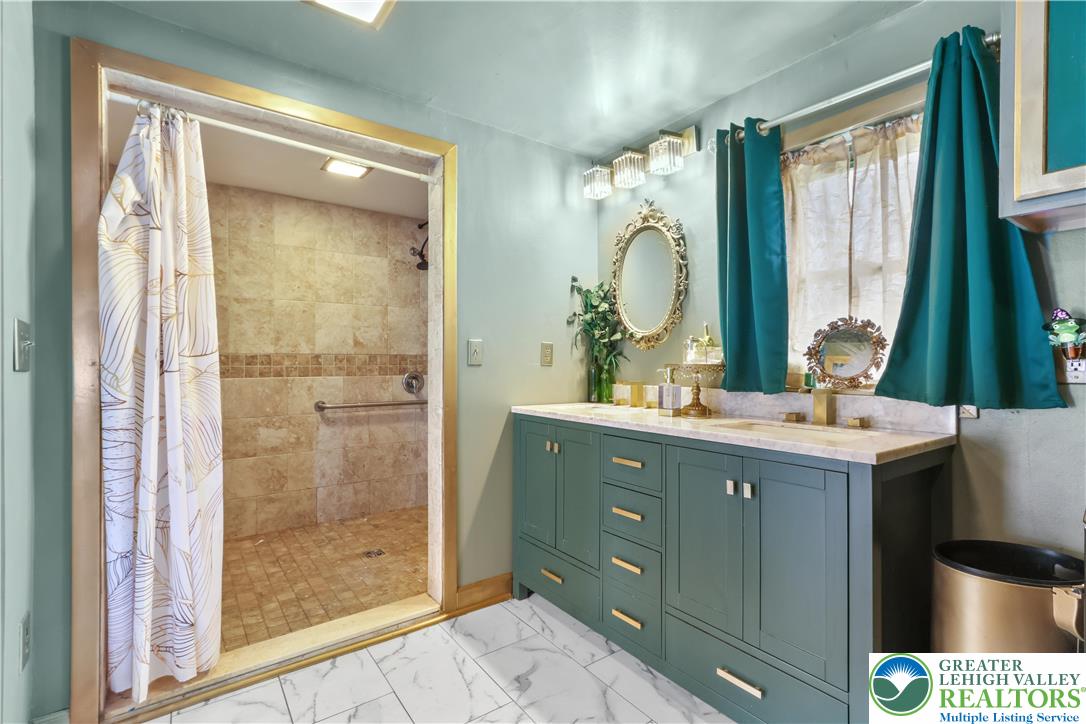 1042 Neffs Laurys Road Laurys Station, PA 18059 - Photo 17 of 27 a bathroom with a double vanity sink mirror and shower