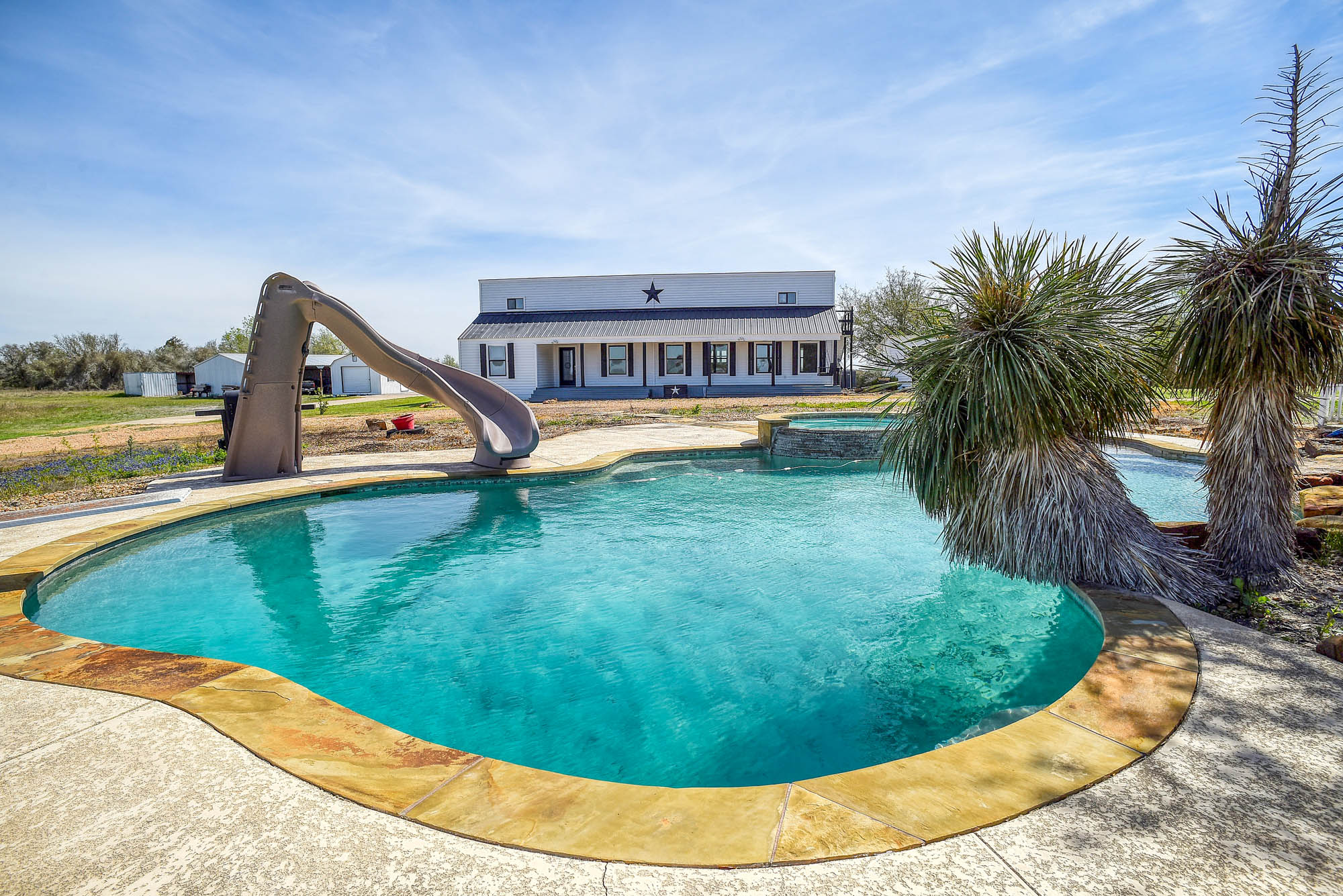 4165 Pin Oak Road Muldoon, TX 78949 - Photo 1 of 44 Integrated pool / spa with a water slide and a patio area