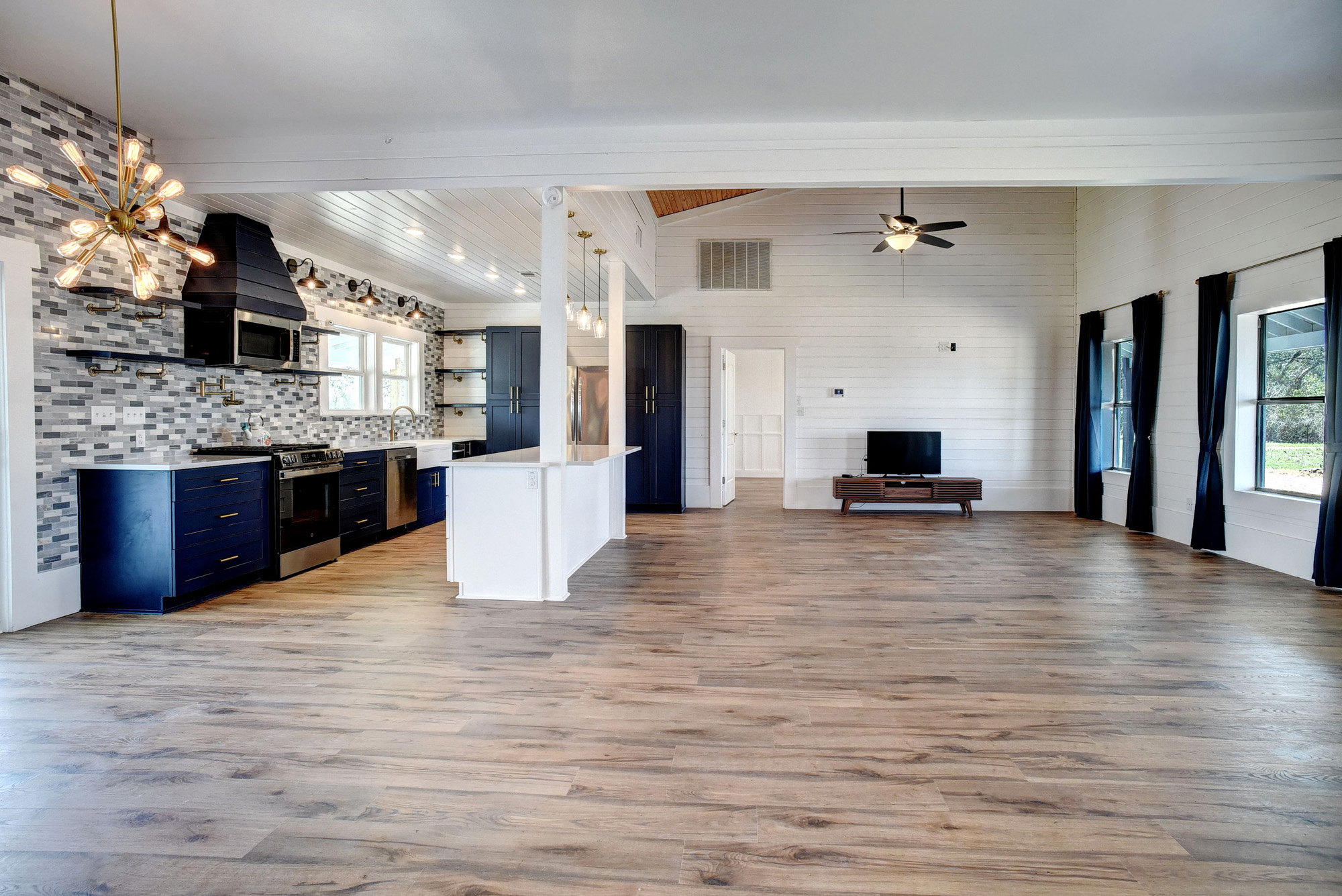 4165 Pin Oak Road Muldoon, TX 78949 - Photo 44 of 44 Kitchen featuring open floor plan, open shelves, light countertops, stainless steel appliances, and blue cabinetry