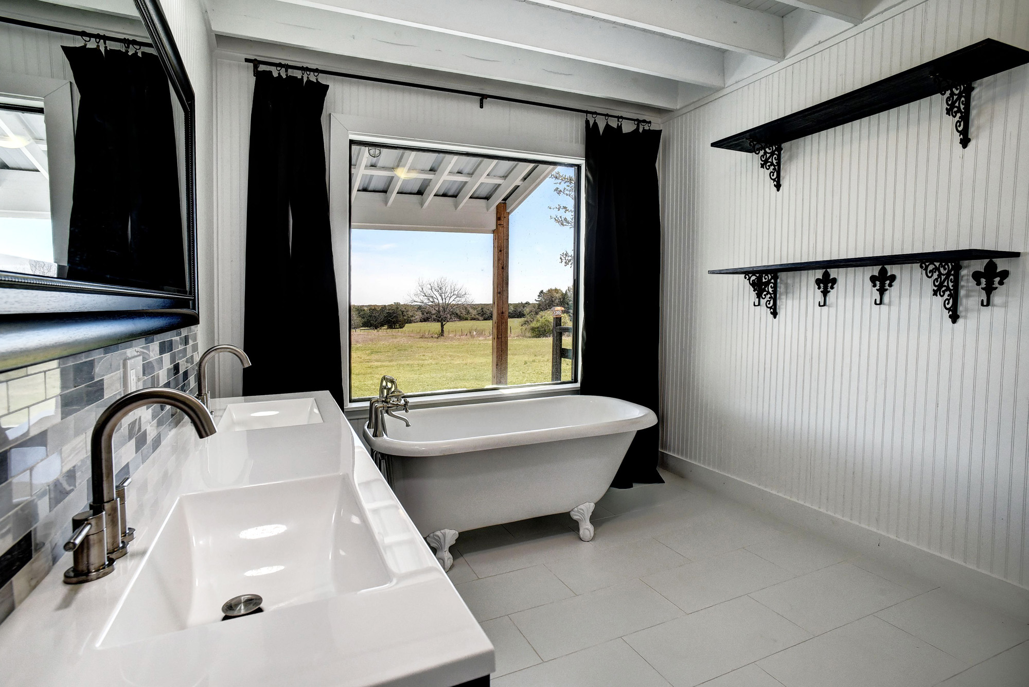 4165 Pin Oak Road Muldoon, TX 78949 - Photo 17 of 44 Bathroom with double vanity, a freestanding bath, and light tile patterned floors
