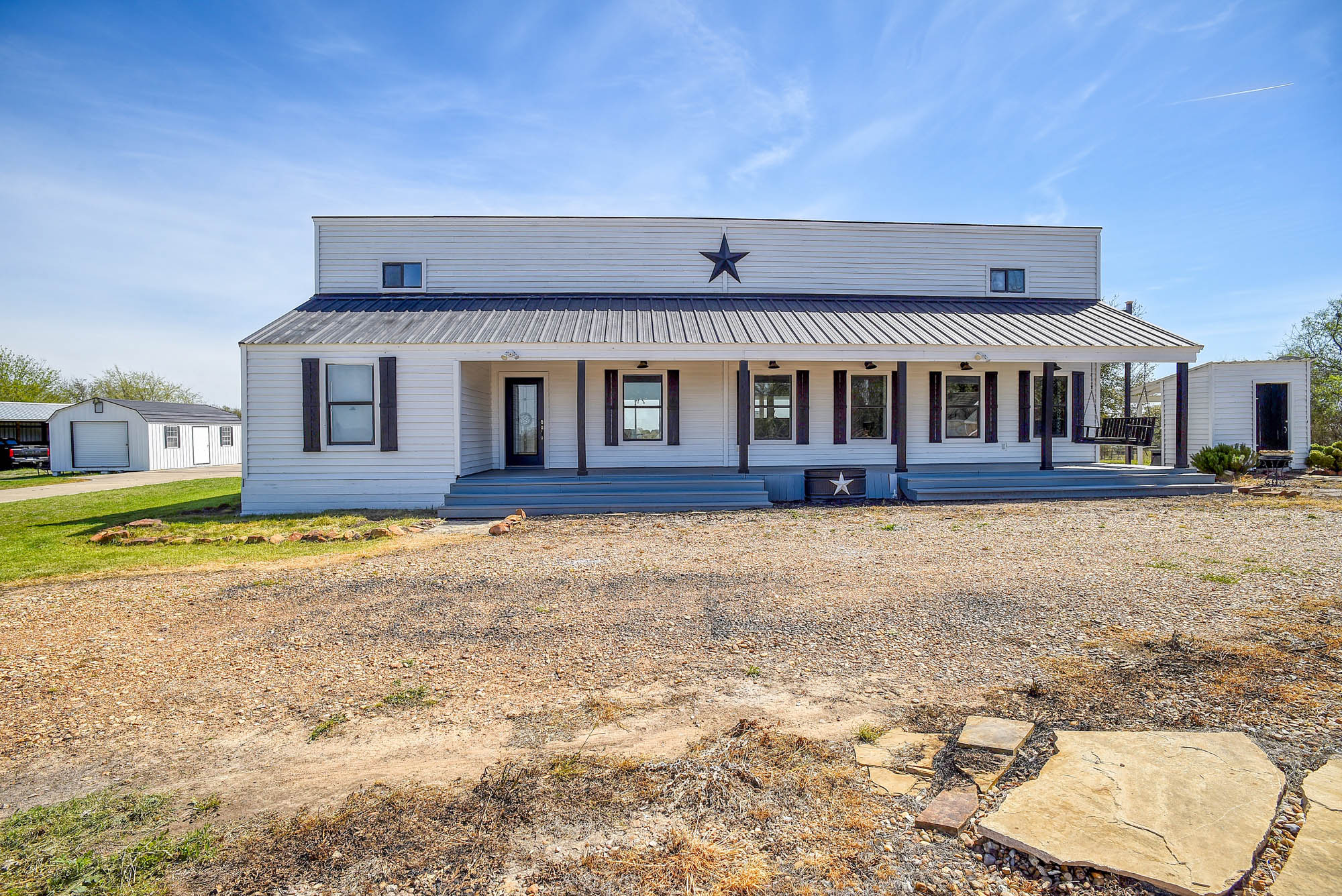 4165 Pin Oak Road Muldoon, TX 78949 - Photo 2 of 44 View of front of house featuring covered porch, a metal roof, and an outbuilding