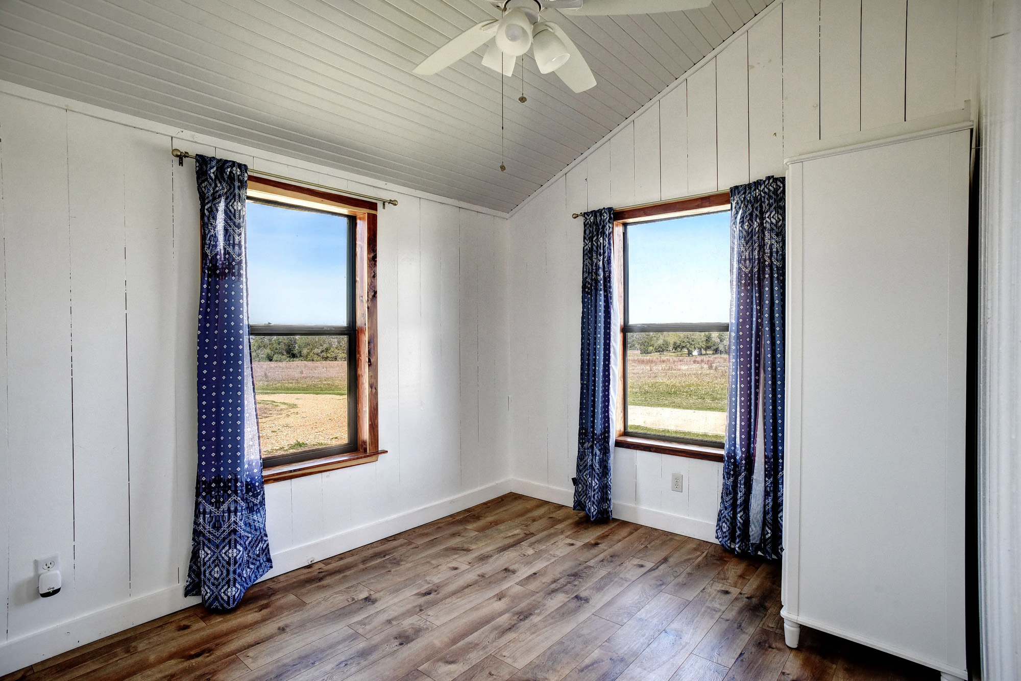 4165 Pin Oak Road Muldoon, TX 78949 - Photo 23 of 44 Empty room with dark wood-type flooring, a ceiling fan, plenty of natural light, wooden walls, and a vaulted wood ceiling
