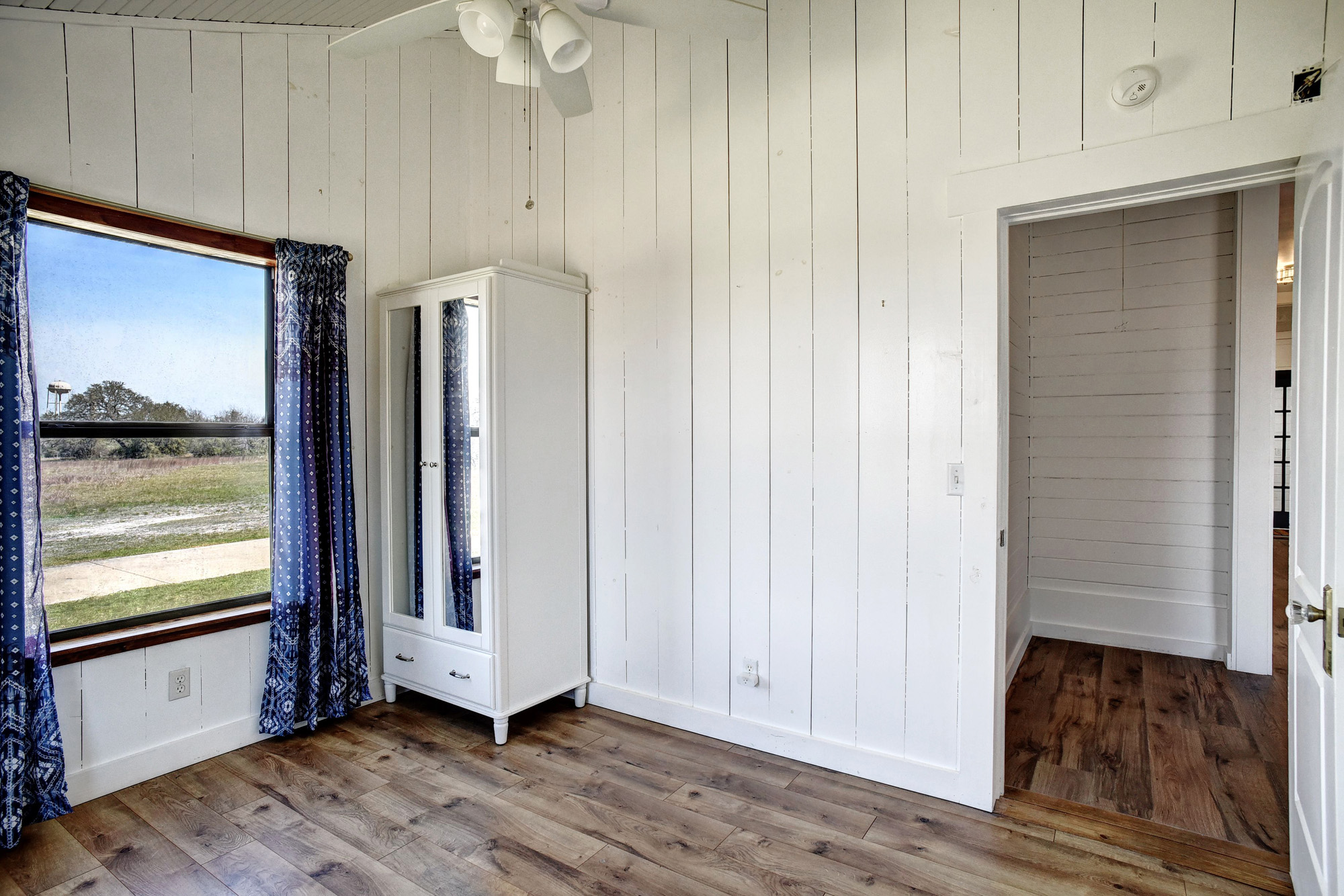 4165 Pin Oak Road Muldoon, TX 78949 - Photo 24 of 44 Unfurnished bedroom with wood-type flooring and wood walls