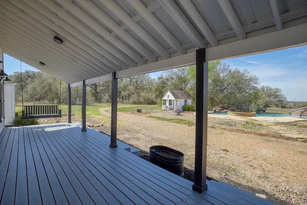 a view of porch with wooden floor