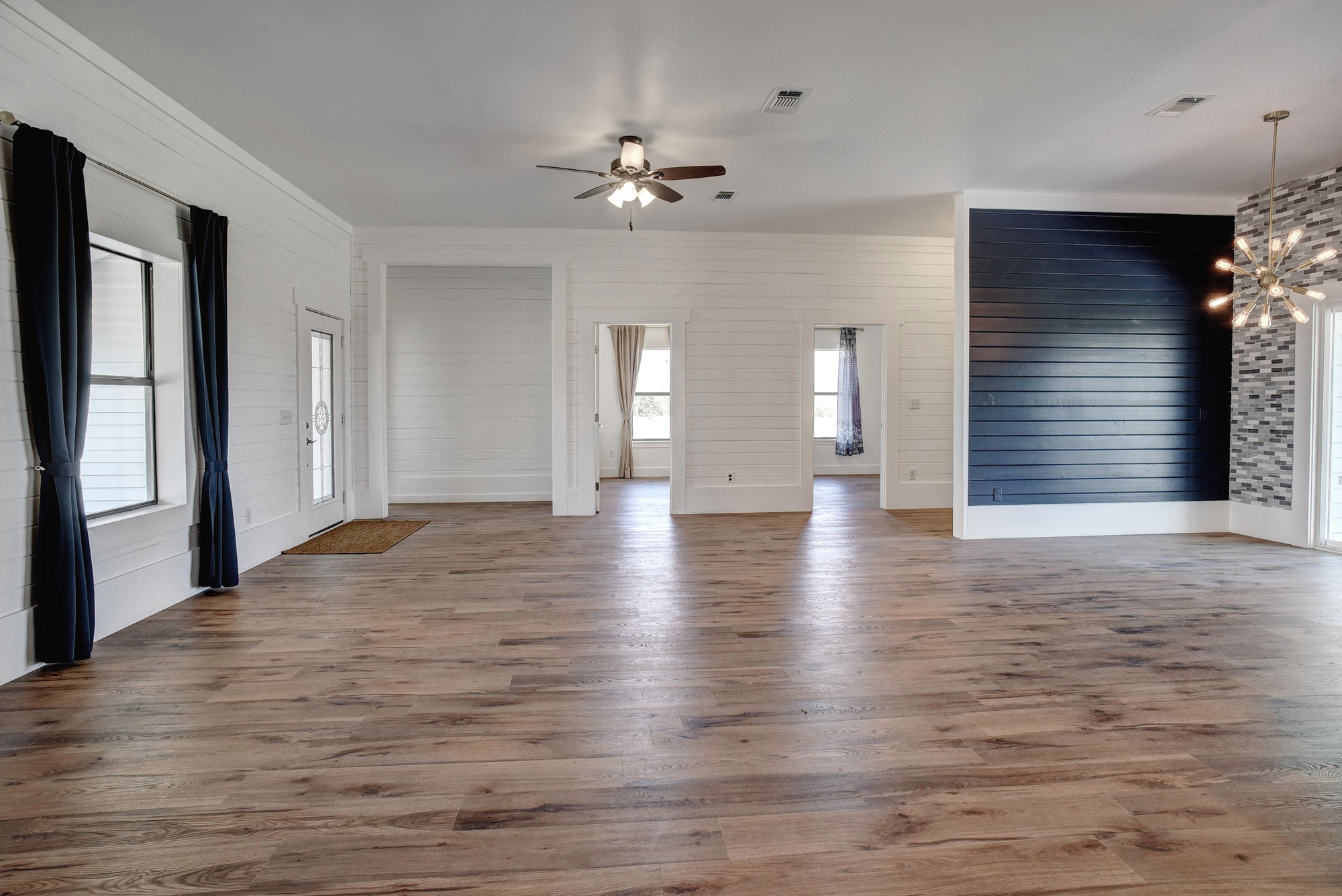 4165 Pin Oak Road Muldoon, TX 78949 - Photo 8 of 44 Unfurnished living room featuring dark wood-type flooring, a chandelier, and ceiling fan