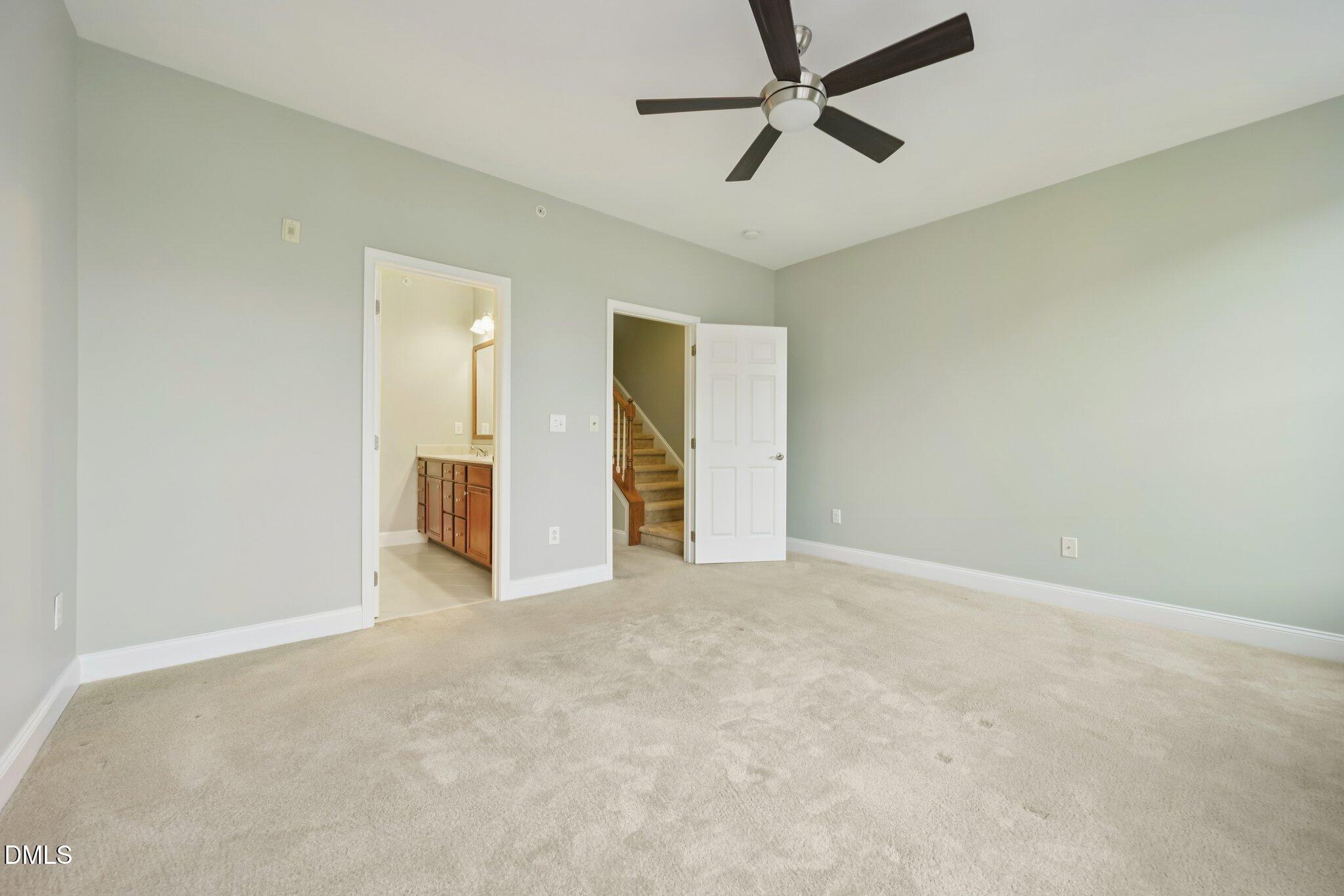 10510 Sablewood Drive, Unit 113 Raleigh, NC 27617 - Photo 24 of 38 an empty room with chandelier fan and windows