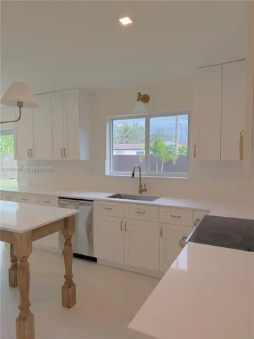 a kitchen with sink cabinets and window