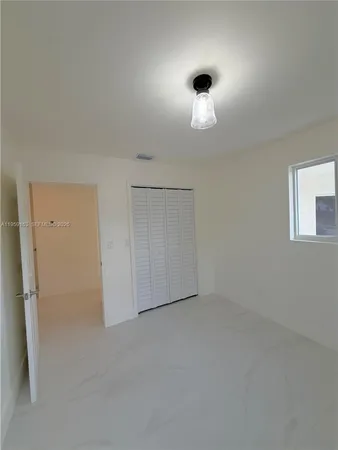 an empty room with a empty space and windows