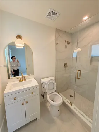 a bathroom with a shower and toilet