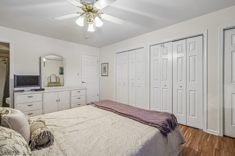 27 Espy Road, Unit A7 Caldwell, NJ 07006 - Photo 14 of 29 a spacious bedroom with a bed and a chandelier
