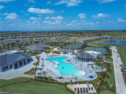 an aerial view of a house with yard swimming pool and outdoor seating