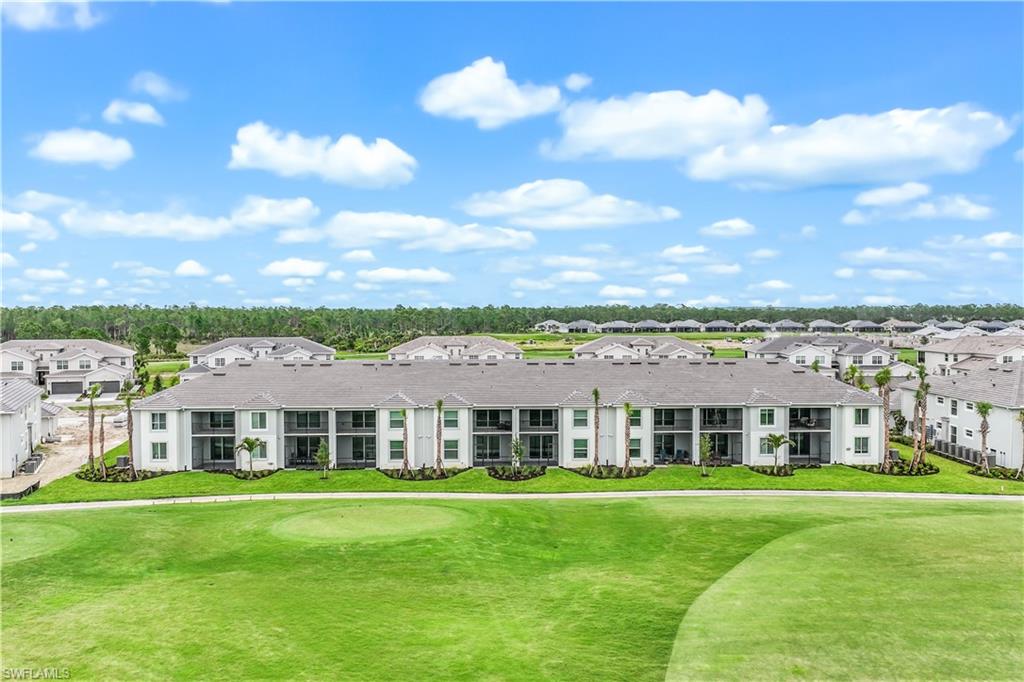 15950 Grassland Lane, Unit 2623 Babcock Ranch, FL 33982 - Photo 16 of 16 a view of a big yard with table and chairs and plants