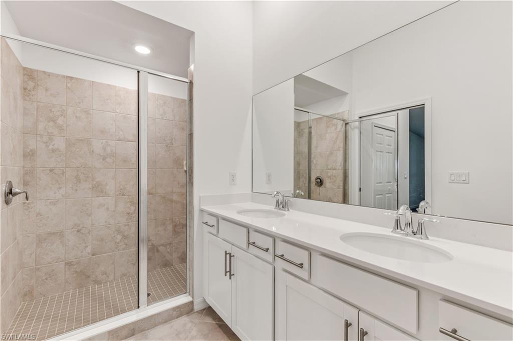 15950 Grassland Lane, Unit 2623 Babcock Ranch, FL 33982 - Photo 3 of 16 a bathroom with a shower sink and mirror