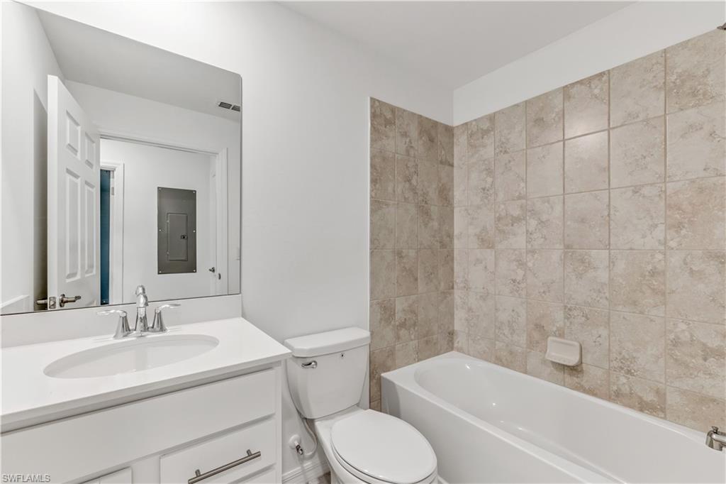 15950 Grassland Lane, Unit 2623 Babcock Ranch, FL 33982 - Photo 4 of 16 a bathroom with a sink toilet and shower