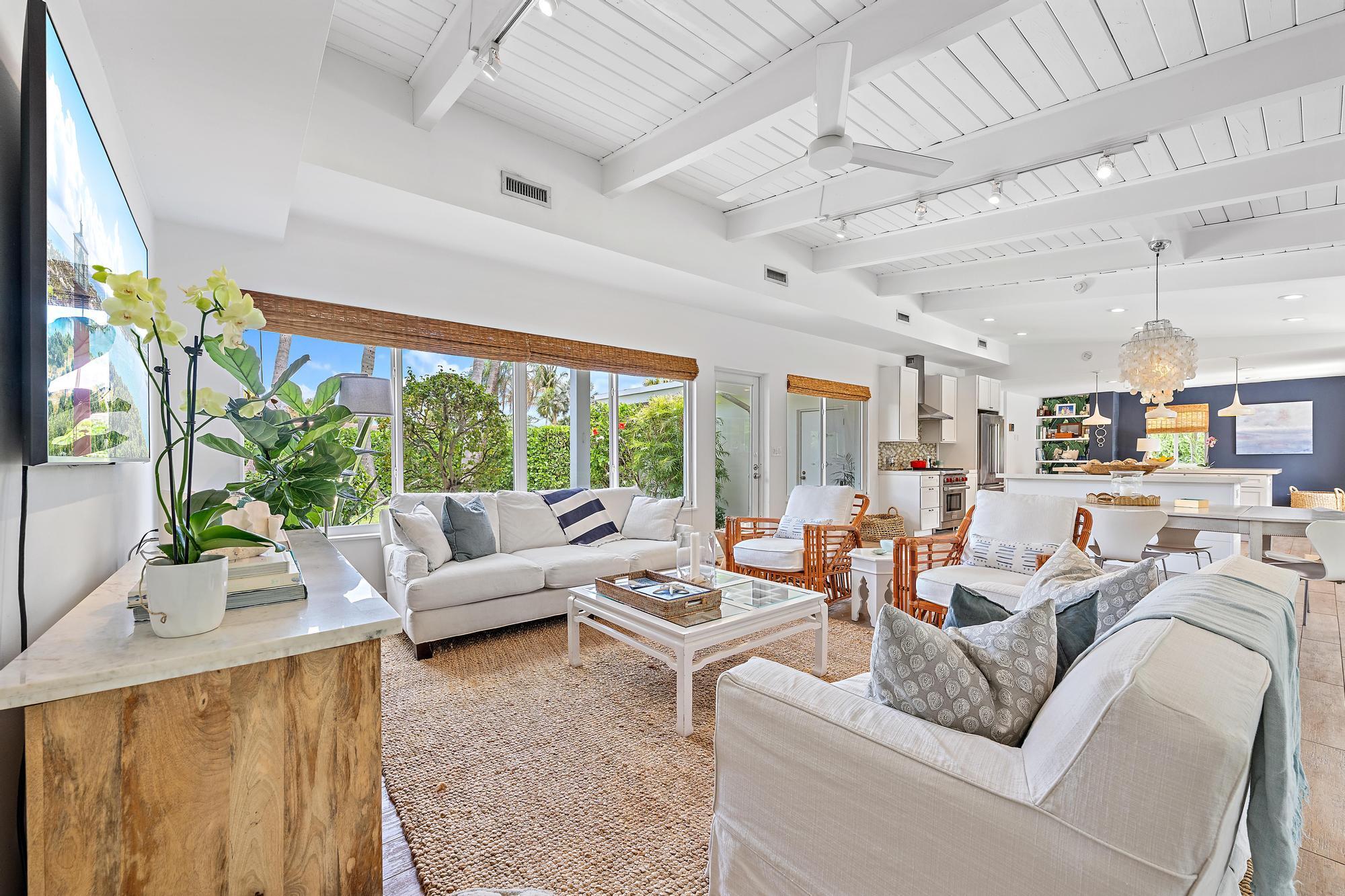 a living room with furniture and large windows