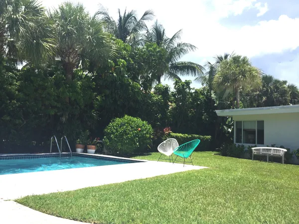 a view of a backyard with plants and a patio