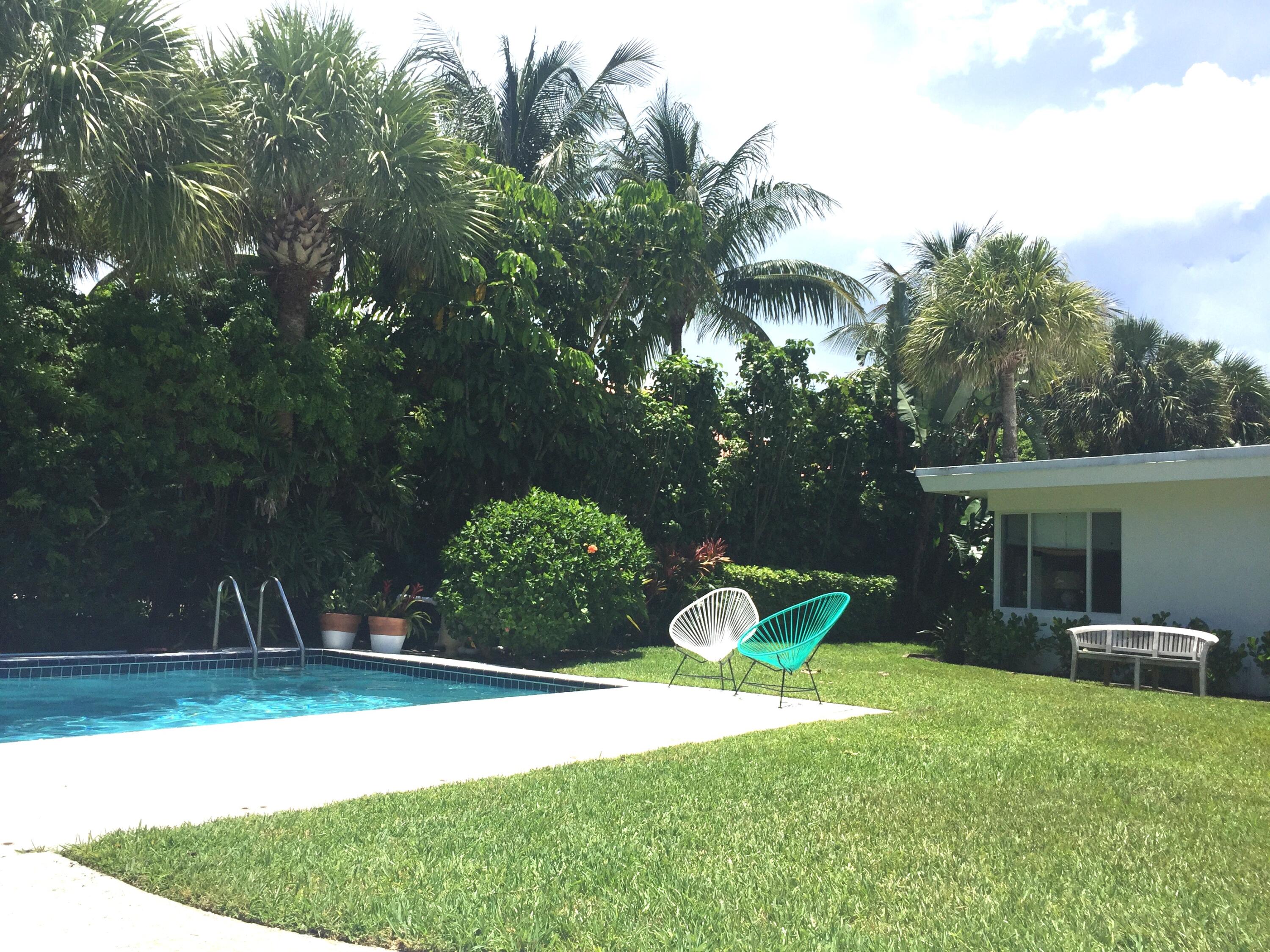 145 Beacon Lane Jupiter Inlet Colony, FL 33469 - Photo 2 of 15 a view of a backyard with plants and a patio